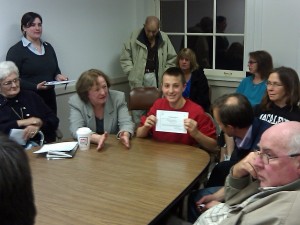 After arguing his own case before the Framingham Board of Health, Peter Jacobson proudly displays the permit he was granted to keep six chickens at his Maple Street home. (October 25, 2011)